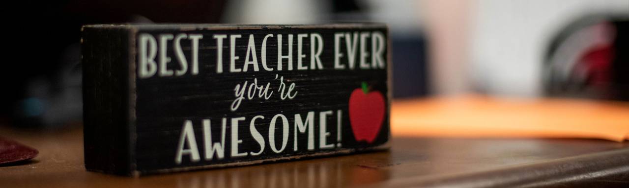 Sign on teacher's desk that says, "Best teacher ever. You're awesome."